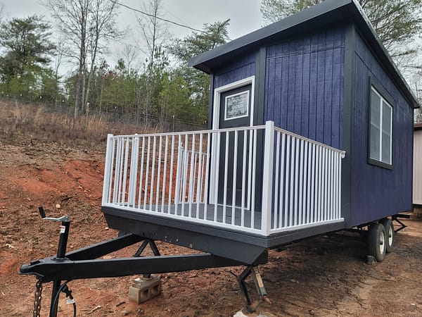 purple tiny house shell with built in porch